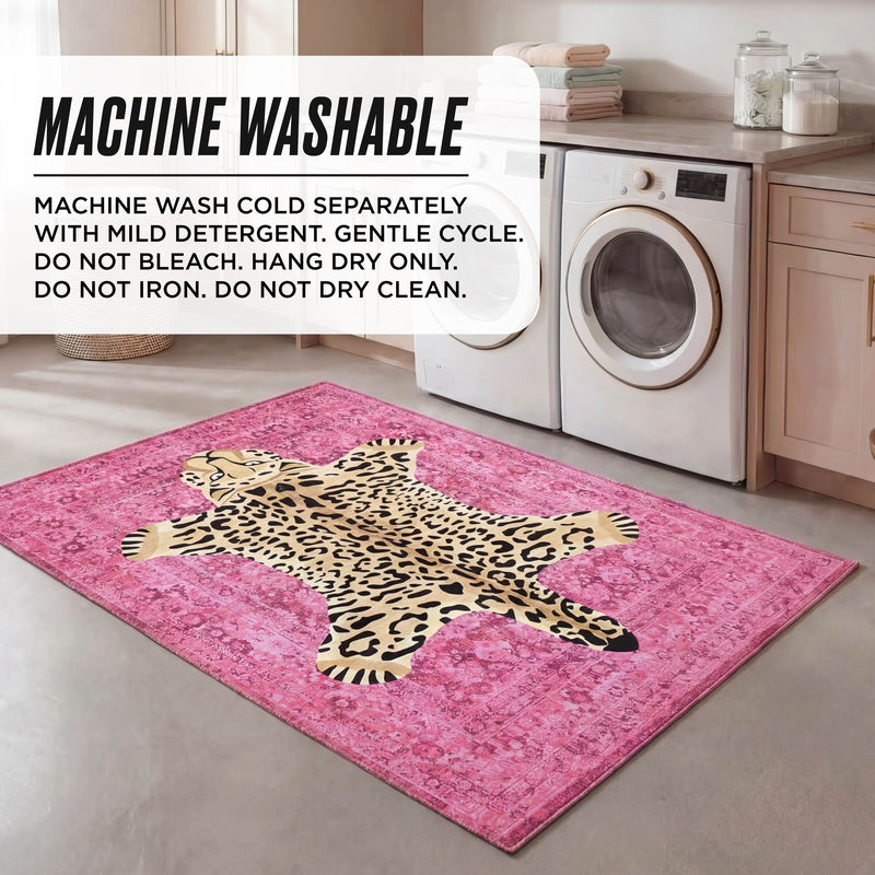 A laundry room with a washing machine, dryer, light cabinets, and a pink, ultra-soft leopard print Finely Washable Rug (3' x 5'). Text overlay: Machine wash cold, gentle cycle, no bleach, hang dry only; do not iron or dry clean.