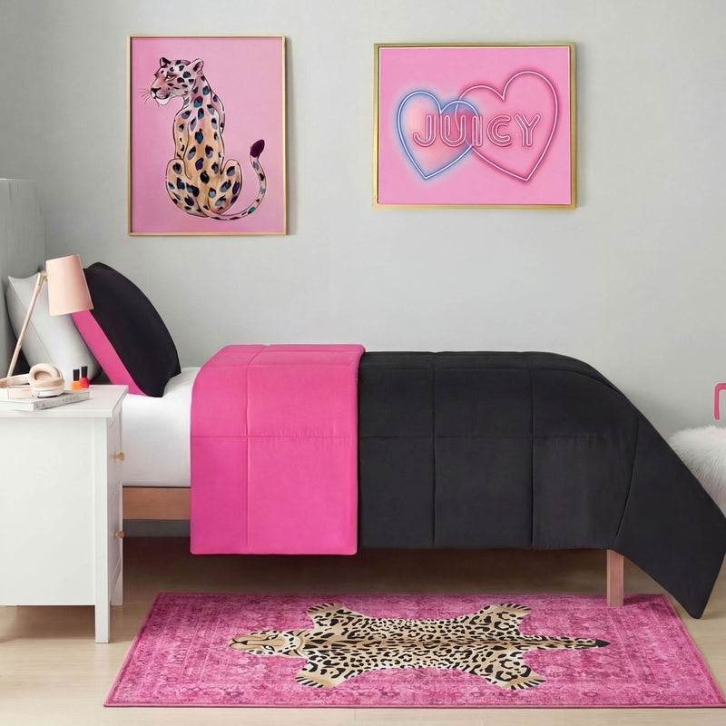 A bedroom with a black and hot pink bedspread, white nightstand, and the Finely Washable Rug (3' x 5'), featuring a leopard. The wall displays two framed art pieces: a cheetah illustration and neon-style "JUICY" text inside heart shapes.