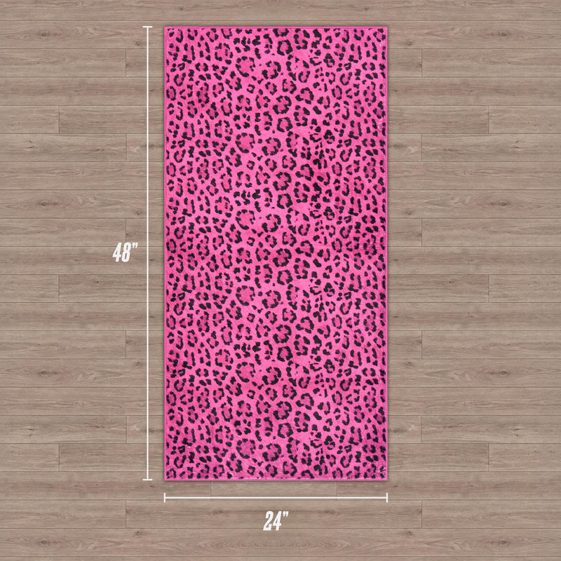 Finely Washable Rug, 2' x 4', rectangular and pink with a black leopard print. It features non-skid backing for safety and is shown on a wooden floor.