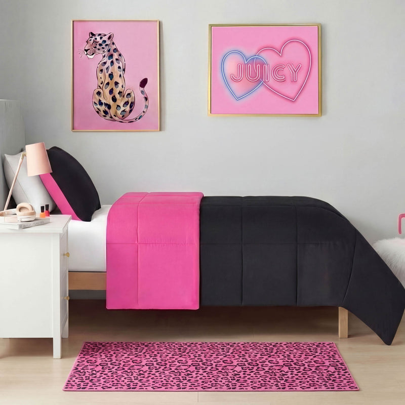 A modern bedroom with a single bed featuring black and bright pink bedding, a white nightstand, a pink lamp, wall art above the bed (leopard illustration and “JUICY” in neon), and a Finely Washable Rug, 2' x 4', with non-skid backing for added flair.