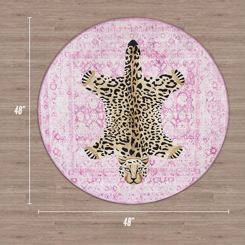 The Finely Washable Round Rug is pink with a central leopard-print design, measures 48 inches in diameter, and has a non-skid backing for added safety on wooden floors.