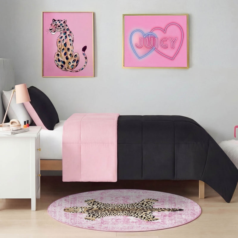 A modern bedroom with a twin bed in pink and black bedding, a white nightstand, pink leopard-themed art, and the Finely Washable Round Rug featuring chic leopard print and non-skid backing adding flair to the floor.