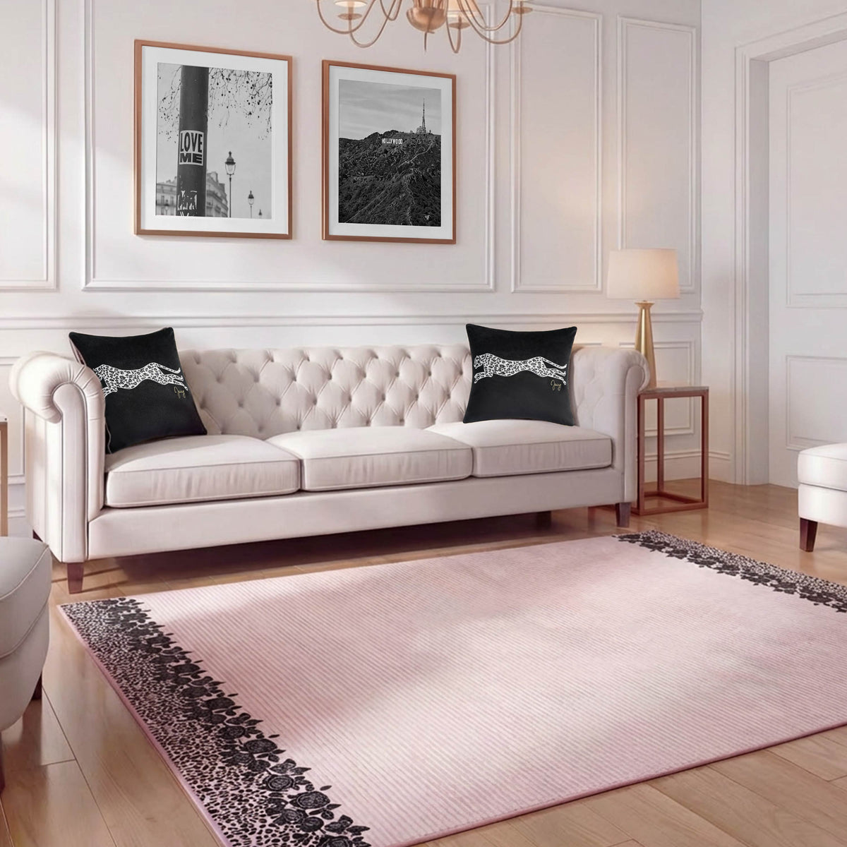 A stylish living room featuring a tufted beige sofa, two black cheetah-print pillows, a Finely Washable Rug (7'10" x 10'), two framed black-and-white photos on the wall, and a gold floor lamp.