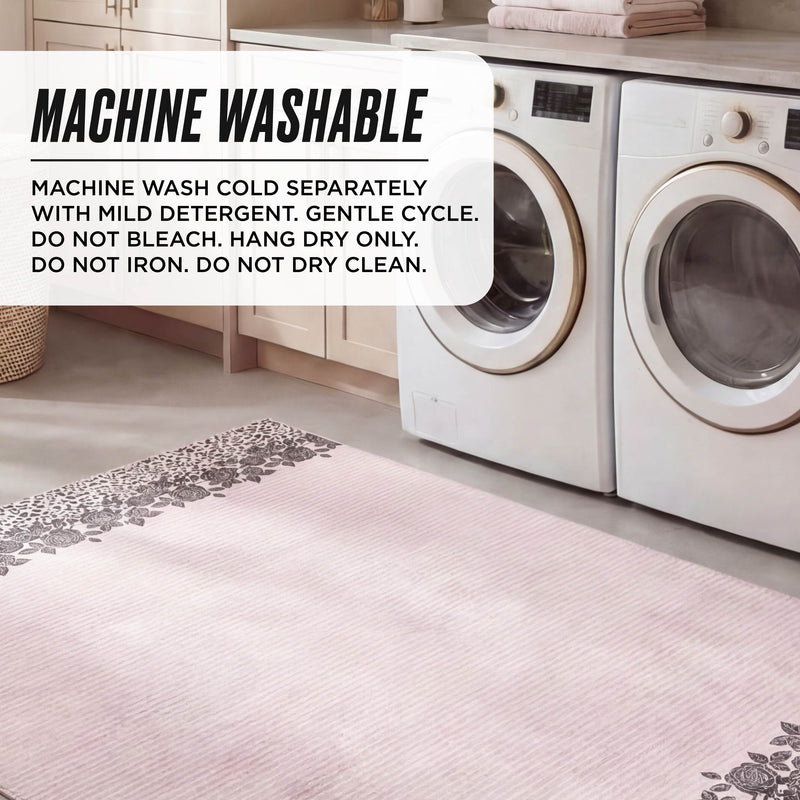 A laundry room features the Finely Washable Rug (7'10" x 10'), pink and floral, in front of the washer and dryer. Text box: Machine wash cold separately, gentle cycle, no bleach, hang dry, do not iron or dry clean.