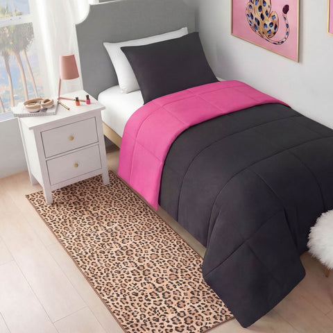 A neatly made twin bed with dark gray and hot pink bedding sits by a white nightstand. A modern vibe is added with a Finely Washable Rug, 2' x 6', and wall art featuring a pink and leopard-print design.