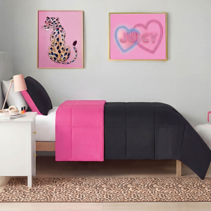 A neatly made twin bed with black and hot pink bedding is set against a light gray wall, below two framed pictures: a leopard illustration and one with JUICY in pink hearts. On the floor lies a Finely Washable Rug, 2' x 6'.