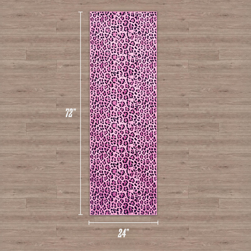 A Finely Washable Rug (2' x 6') with a pink and purple leopard print is laid on a light wood floor. The ultra-soft rectangular rug features measurement lines and labels, and it is machine-washable for easy care.
