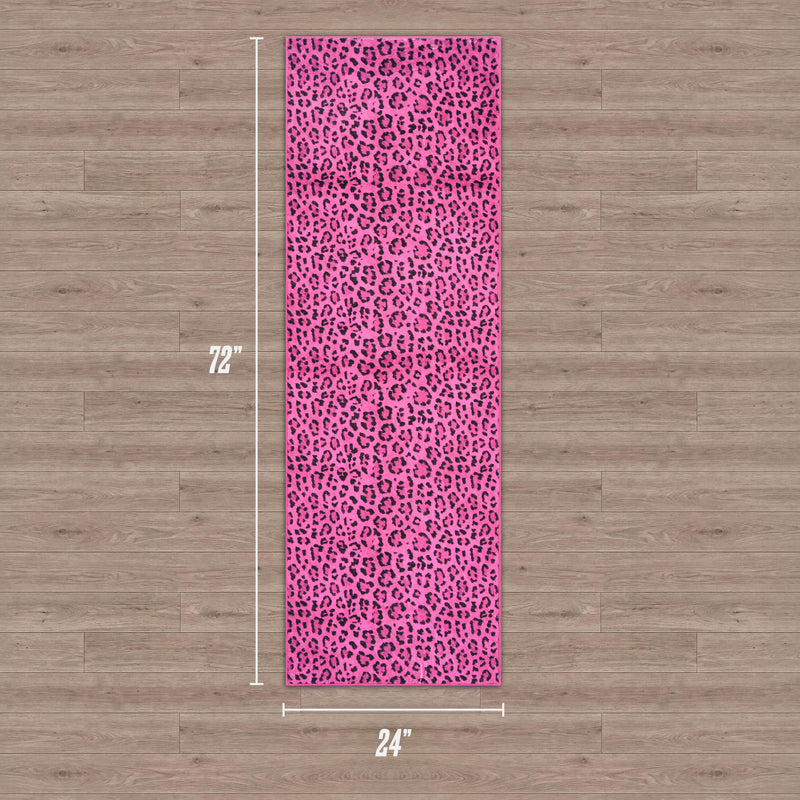 A rectangular pink Finely Washable Rug, 2' x 6', with black leopard print rests on a wooden floor. White text displays its size: 72 inches long and 24 inches wide.
