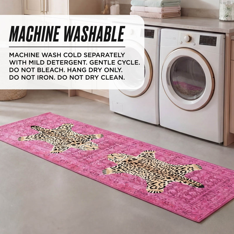 A pink Finely Washable Rug, 2' x 6', with two leopard designs sits on a laundry room floor by the washer and dryer. Text overlay gives care instructions: machine wash cold, hang dry only.