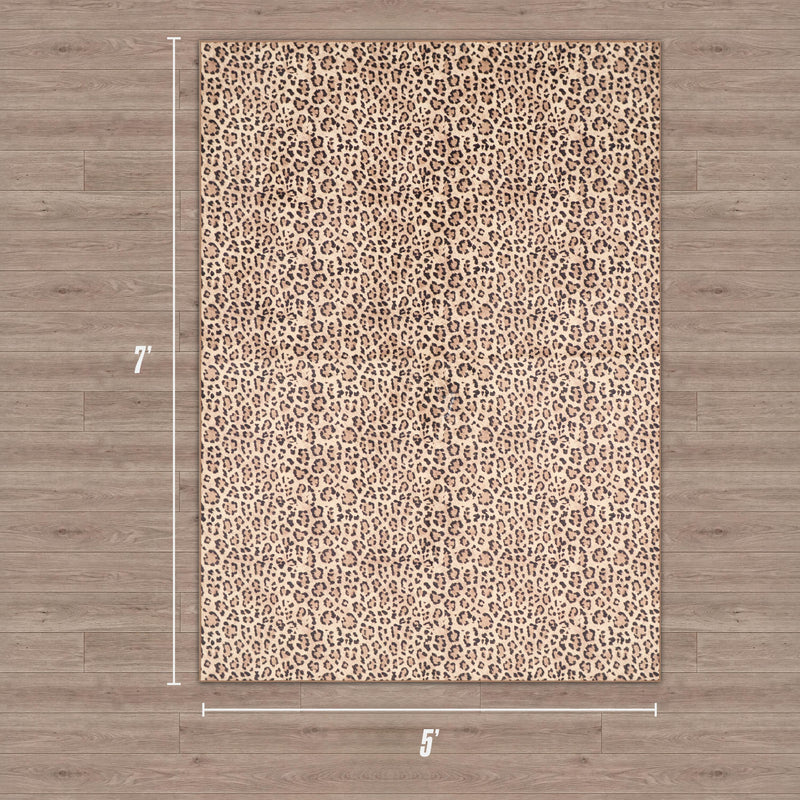 A Finely Washable Rug, 5' x 7', with a leopard print pattern is displayed on a wooden floor. White measurement lines highlight its size, and it features a non-skid backing for added safety.