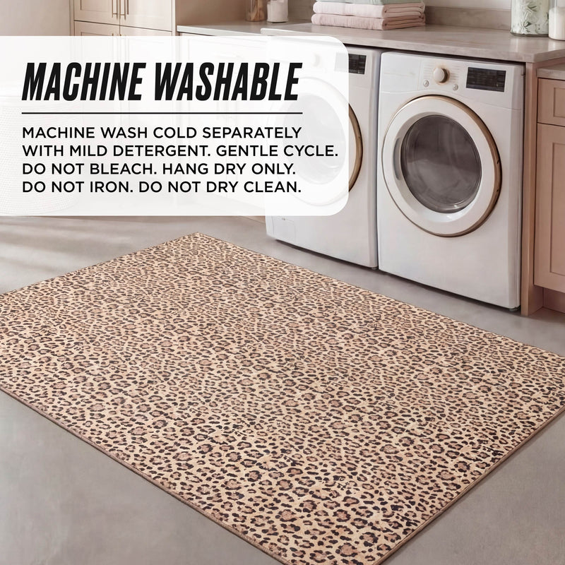 A Finely Washable Rug, 5' x 7', with leopard print is placed in front of a washer and dryer. Text overlay: Machine washable cold, gentle cycle, non-skid backing. Do not bleach, iron, or dry clean; hang dry only.