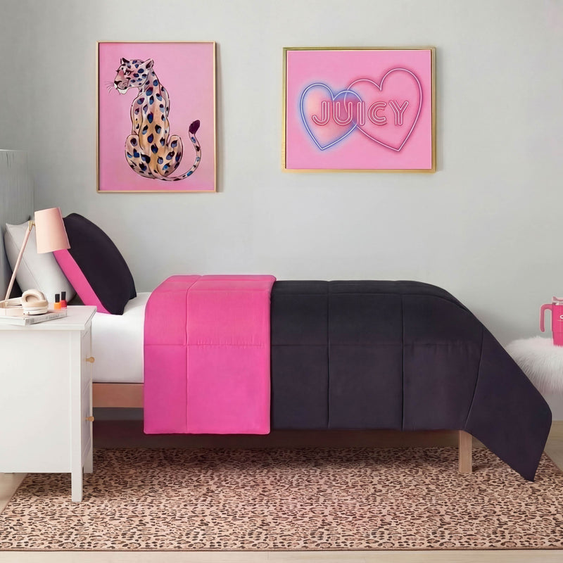 A neatly made bed with black and bright pink bedding sits against a light gray wall. Two framed art pieces hang above, while the Finely Washable Rug, 5' x 7', with non-skid backing, adds style next to the white nightstand.