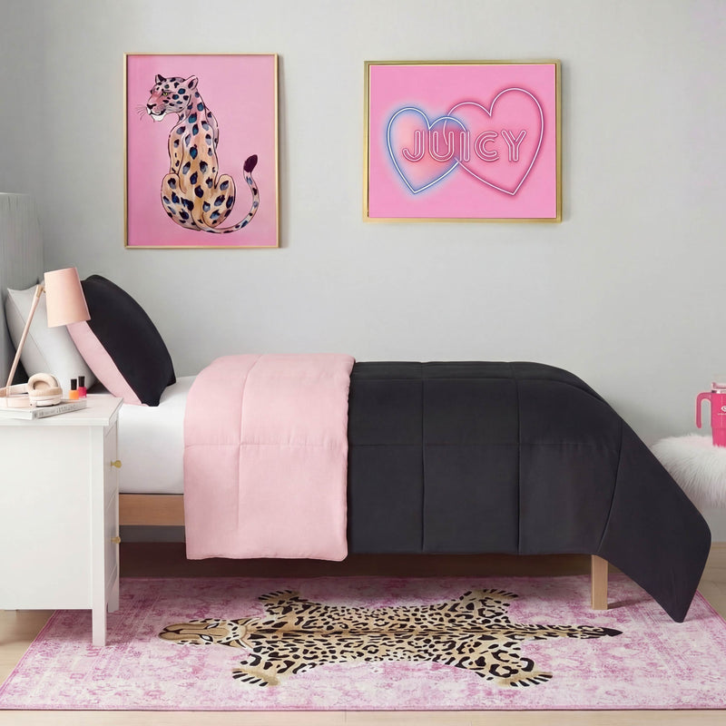 A modern bedroom features a bed with black and pink bedding, the Finely Washable Rug (5' x 7') in cheetah print, and two framed pink wall art pieces: one of a cheetah and another saying “JUICY” in neon-style font with two hearts.