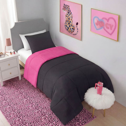 A neatly made twin bed with a black and hot pink comforter, black pillow, gray headboard, and white nightstand. The room features pink leopard-print decor, including a Finely Washable Rug (5' x 7'), wall art, and a fluffy white stool.
