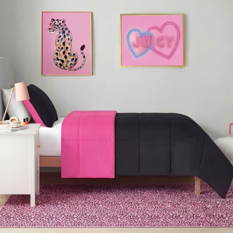 A modern bedroom with a white bed in black and bright pink bedding, a white nightstand, the Finely Washable Rug (5' x 7') in pink leopard print, and two framed pink wall art pieces—a leopard and JUICY inside hearts.