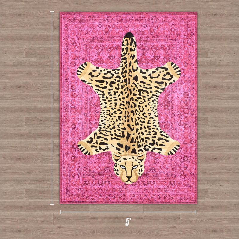 The Finely Washable Rug, 5' x 7', comes in pink with a leopard-print design resembling a spread-out leopard skin. Ultra-soft and machine-washable, this rectangular rug adds style to any wooden floor.