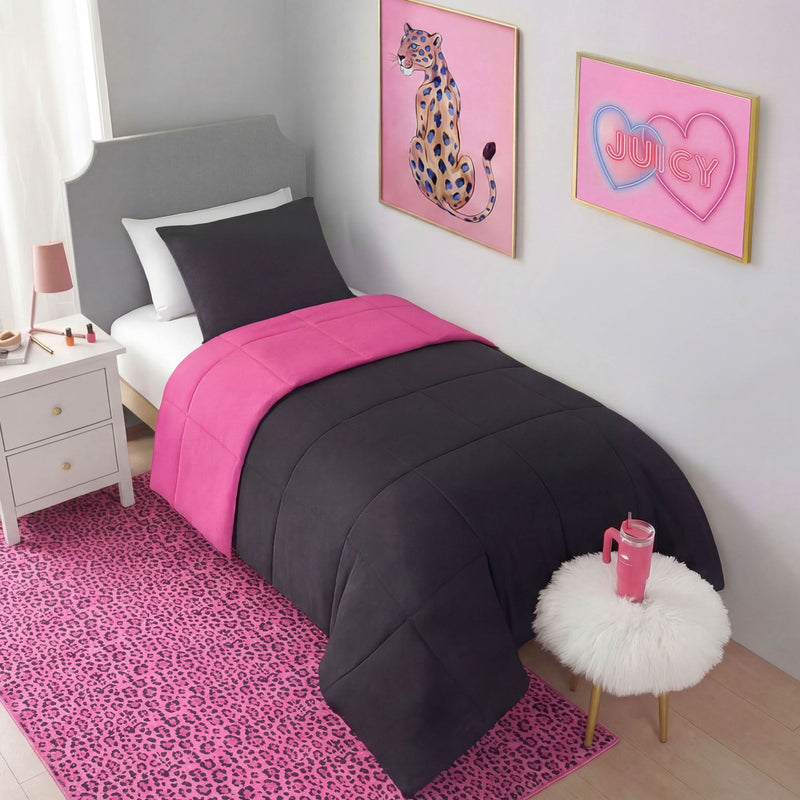 A twin bed with a black and hot pink comforter, black pillow, and gray headboard. The room features pink leopard-print decor, a nightstand, leopard wall art, a “Juicy” sign, and a Finely Washable Rug (5' x 7') for ultra-soft comfort.