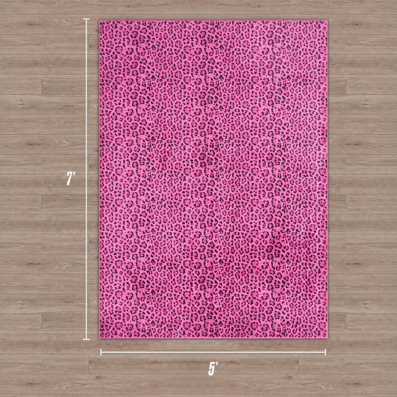 The Finely Washable Rug, 5' x 7', features a pink and purple leopard print in a rectangular shape, shown on a light wood floor with white measurement lines highlighting its ultra-soft texture.