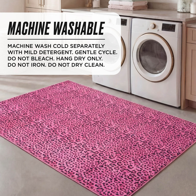 A pink leopard-print Finely Washable Rug, 5' x 7', adds flair to the laundry room floor in front of the washer and dryer, with washing instructions noted in the corner for this ultra-soft, machine-washable rug.
