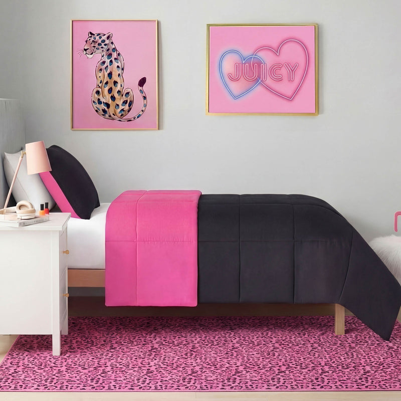 A modern bedroom with a black and hot pink bed, white nightstand, and an ultra-soft, machine-washable Finely Washable Rug (5' x 7') in pink leopard print. Framed art on the wall includes a cheetah illustration and a JUICY sign in pink hearts.