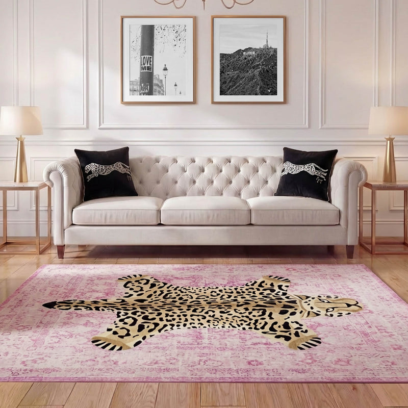 Elegant living room with a white tufted sofa, two black cheetah-print pillows, a Finely Washable Rug (7'10" x 10') with a cartoon cheetah motif, two lamps, and two framed black-and-white wall photos.