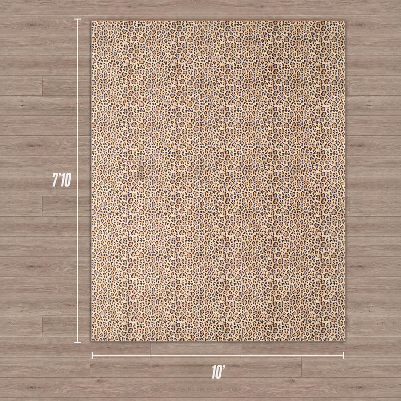 The Finely Washable Rug, 7'10 x 10', features a rectangular ultra-soft leopard print in tan and brown, resting on a light wood floor. Its plush design ensures comfort and style, with measurements marked on the sides for easy placement.