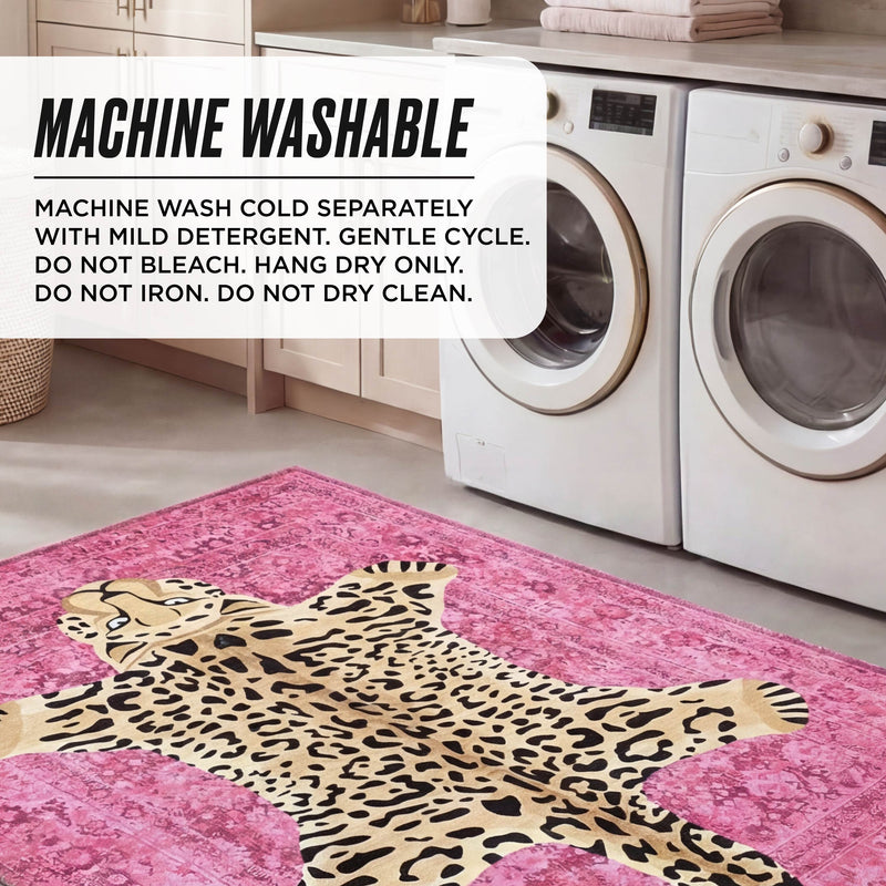 A laundry room with a washer and dryer features an ultra-soft pink Finely Washable Rug (7'10 x 10') with a cartoon leopard on the floor. A text box notes the rug is machine washable and provides care instructions.