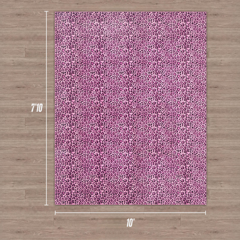 A pink leopard-print Finely Washable Rug (7'10" x 10') is displayed on a light wood floor with white dimension lines. Machine washable and featuring a non-skid backing, it adds safety and style to any room.