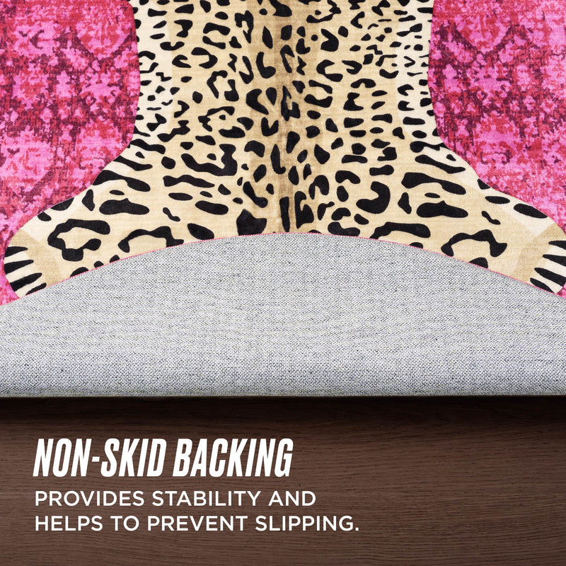 A close-up of the Finely Washable Round Rug featuring an ultra-soft leopard print and a non-skid gray backing, partially lifted to reveal the underside. Text: Non-skid backing adds stability and helps prevent slipping.