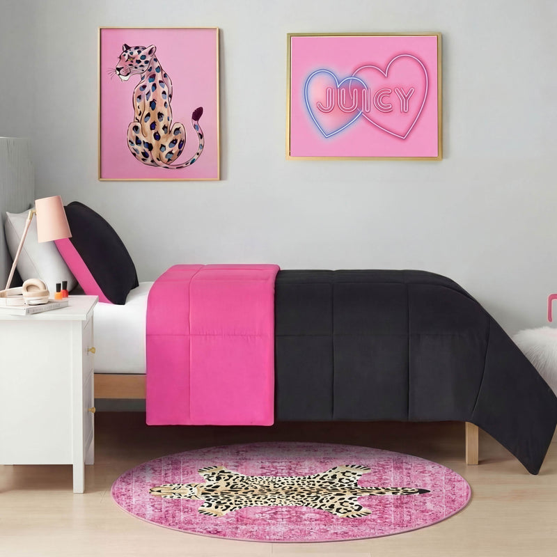 A bedroom with a white bed, black and pink bedding, the Finely Washable Round Rug in pink leopard print, and two framed pink wall art pieces—one featuring a cheetah and another with Juicy in heart shapes—creates vibrant, playful decor.