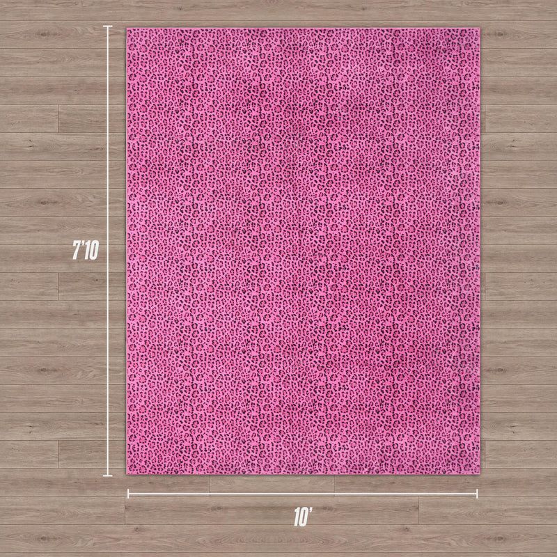 A Finely Washable Rug, 7'10 x 10', in a rectangular pink leopard print, is shown on a wooden floor with white lines and labels indicating its dimensions. The rug is ultra-soft and stylish.