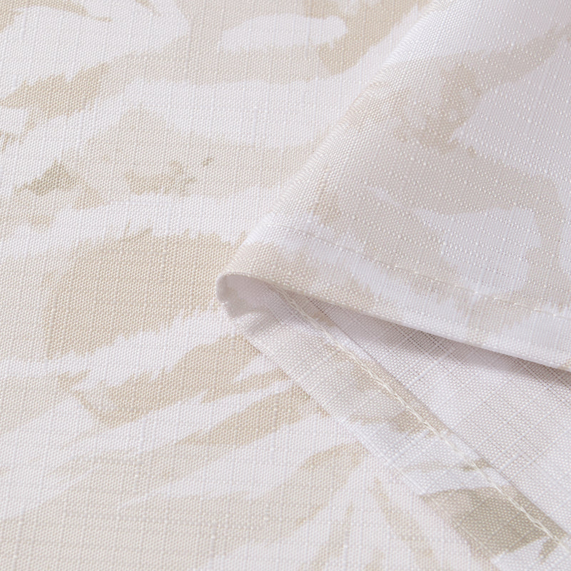 Close-up of the Stassi Shower Curtain with PEVA Liner and Hooks 14-Piece Set, featuring beige and white fabric with a subtle abstract pattern. The fabric is folded to highlight its texture and neatly stitched edges—perfect for elevating your bath decor or making a statement in your bathroom ensemble.