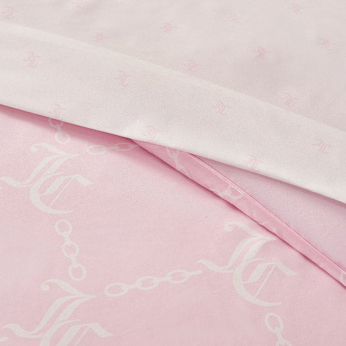 Close-up of overlapping pink and light pink satin fabrics featuring a white chain and monogram pattern, capturing the soft elegance of the Link Printed Bed in a Bag Bedding Set for luxurious sleep.