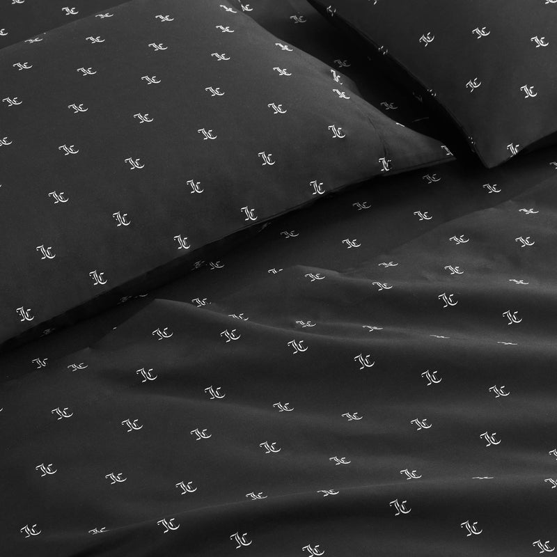The Link Printed Bed in a Bag Bedding Set includes black bed sheets and pillowcases with a bold repeating white logo, arranged neatly on the bed for a sleek, luxurious look and comfortable sleep.