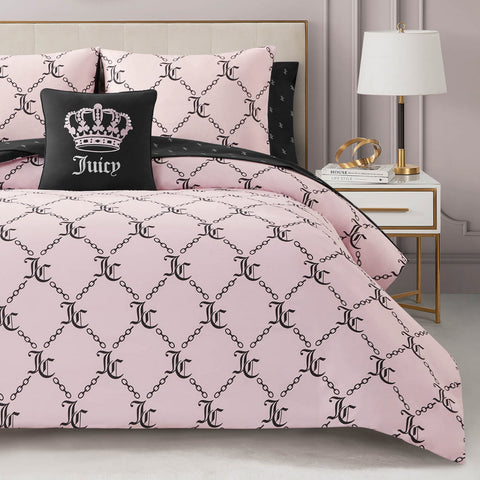 A neatly made bed with the Link Printed Bed in a Bag Bedding Set, featuring pink glam bedding and pillowcases with a black chain pattern, plus a chic black Juicy pillow—ideal for stylish, luxurious sleep.