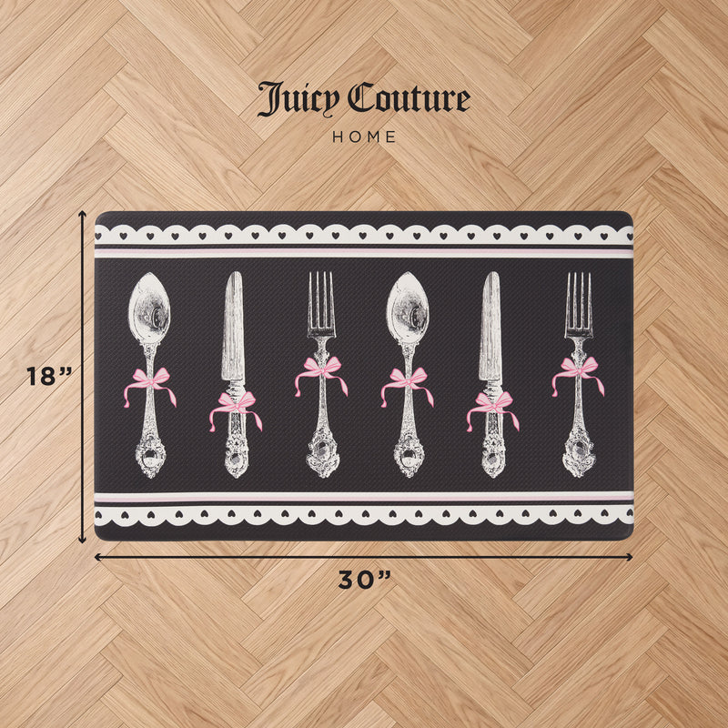 Kitchen Wellness Mat, 18x30, on wood floor. This stylish mat features a vintage silverware design tied with pink bows on a black background with white scalloped edges.