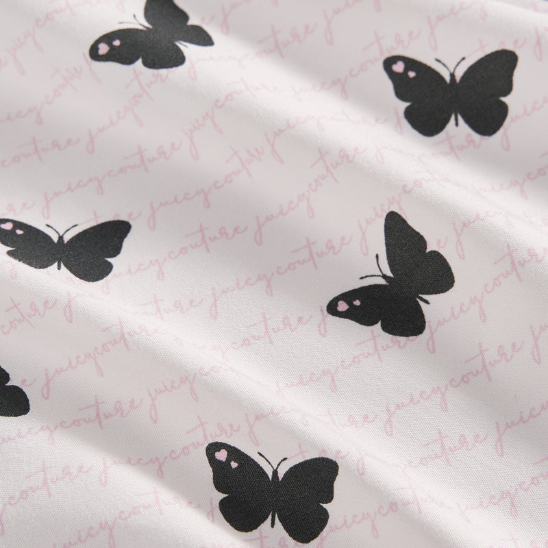 The Printed Microfiber Sheet Set features black butterfly designs and subtle pink Juicy Couture cursive text, bringing a touch of luxury to your bedding ensemble.
