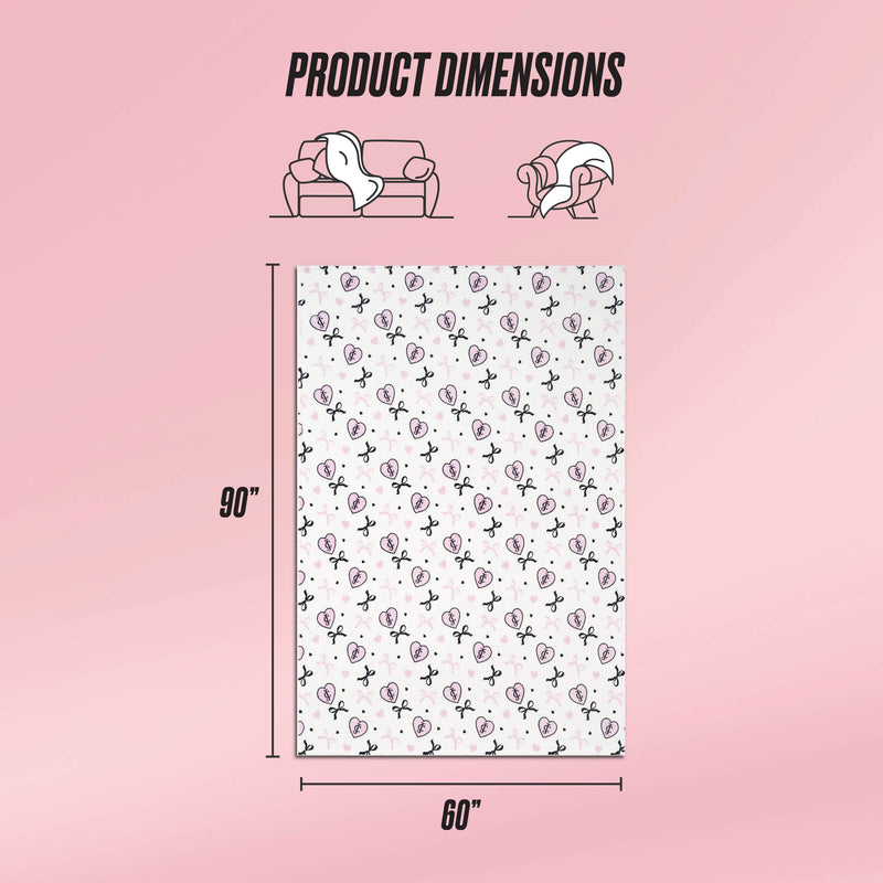 A graphic displays the Plush Oversized Throw Blanket (90"x60") on a pink background. Above, illustrations show its ultra-soft texture as it covers a couch and person. The blanket features a white base with repeating black and pink designs.