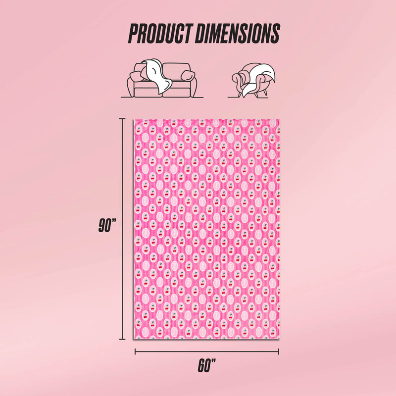 The Plush Oversized Throw Blanket is displayed upright, showing its pink color with a repeating white and red pattern. Measuring 90 x 60 inches, this ultra-soft blanket appears next to couch and person icons for scale under Product Dimensions.