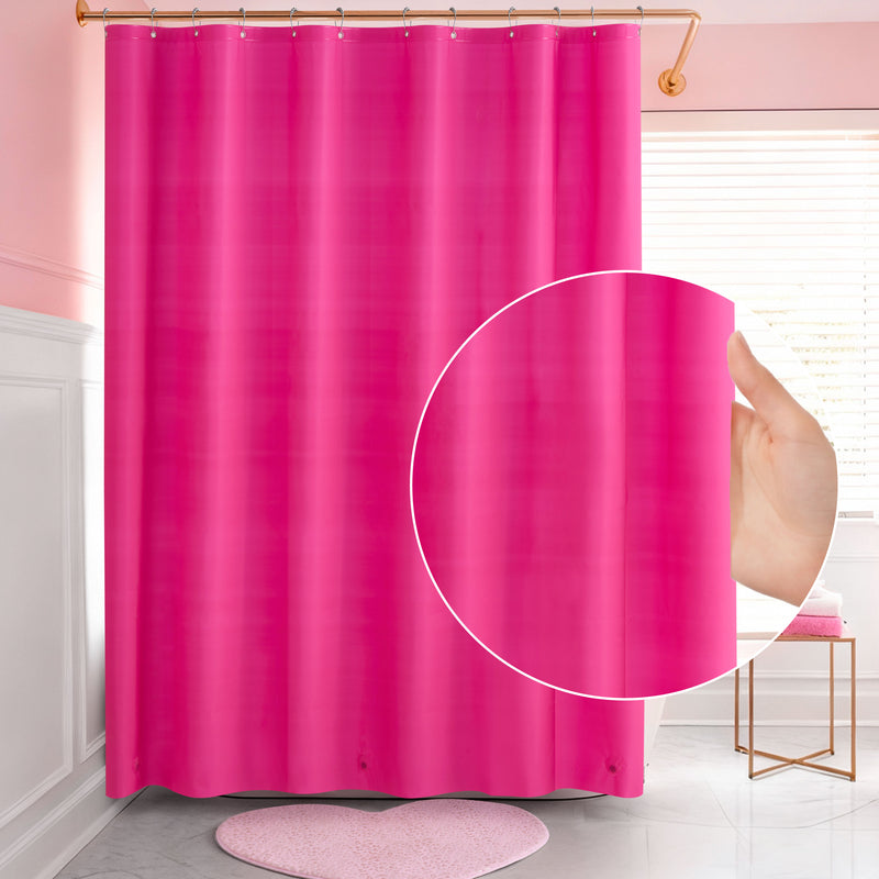 A hand holds a bright pink PEVA Shower Curtain Liner in a bathroom with pink walls, white wainscot, a round pink rug, and a window with white blinds. A circular inset highlights the waterproof liner material up close.