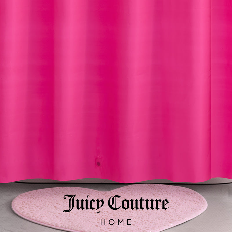 A bright pink PEVA Shower Curtain Liner hangs above a light pink, heart-shaped rug with speckles. The words Juicy Couture Home are printed in black at the bottom center of the image.