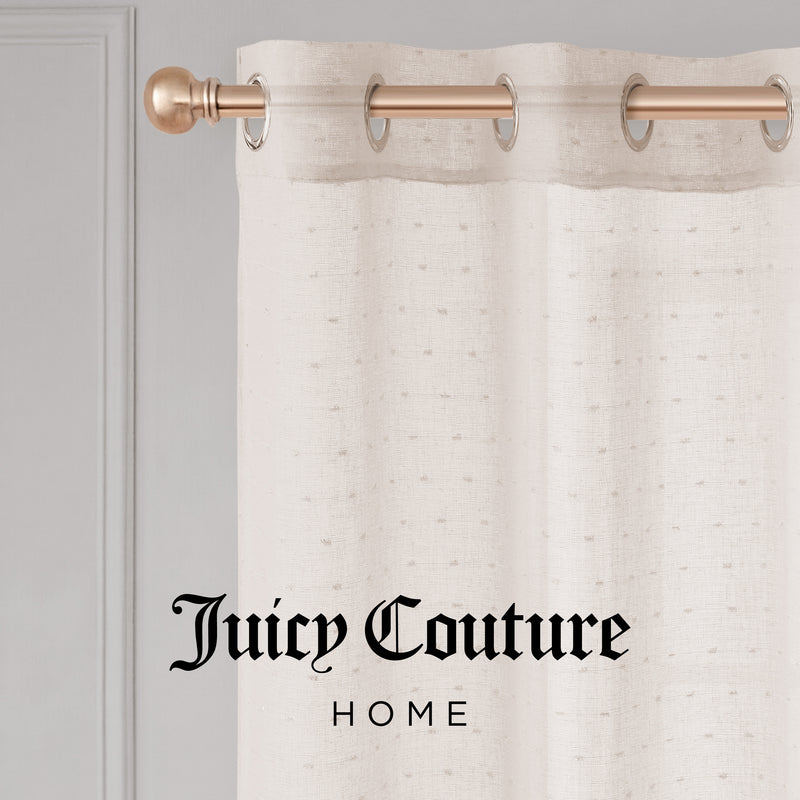 The cream-colored Aurora Sheer Window Curtain with a grommet header hangs on a gold rod. "Juicy Couture HOME" in black script appears at the bottom center of the image.
