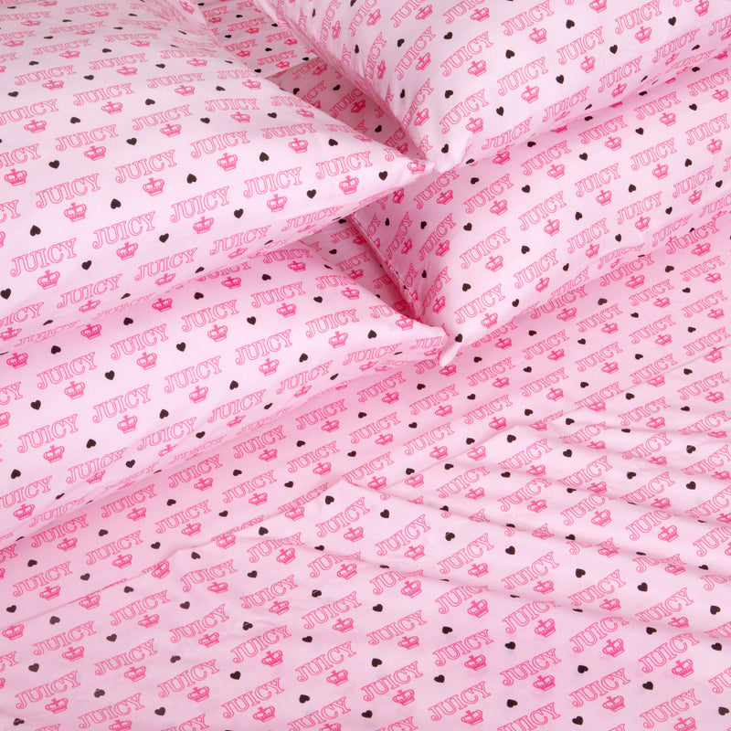 The Microfiber Sheet Set With Extra Pillowcases features ultra-soft pink sheets and pillowcases adorned with a playful, all-over “JUICY” print, accented by hearts, crowns, and stars in varying shades of pink and black. Crafted from smooth microfiber for a youthful touch, this set is perfect for fans of Juicy Couture bedding.