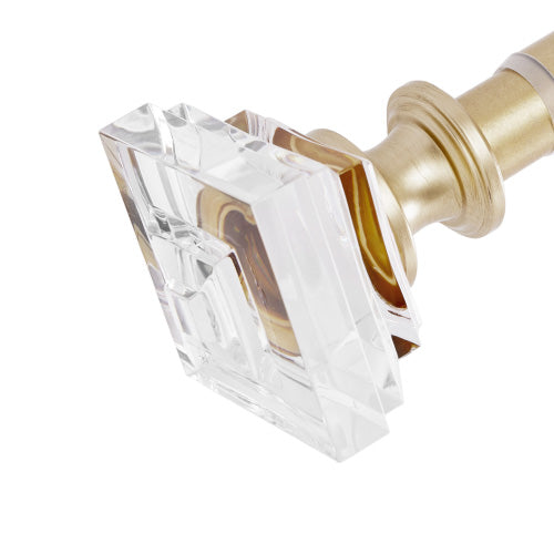 A close-up view of the Rodeo Adjustable Curtain Rod, featuring a gold finish and a geometric clear crystal finial—perfect for elevating your window styling with a touch of Juicy Couture-inspired glam.