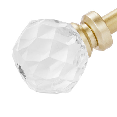 A faceted clear crystal finial lends an elegant touch to the Astoria 2-Piece Adjustable Curtain Rod Set, shown in gold against a white background. Decorative acrylic accents enhance this sophisticated set, bringing timeless charm to your window décor.