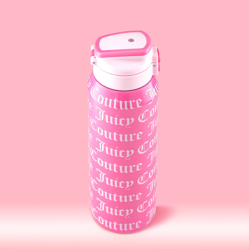 The Glam Getaway Hydration Stainless Steel Tumbler is pink with a white flip-top lid and "Juicy Couture" printed in white cursive. This 32oz tumbler combines style and practicality for everyday hydration.
