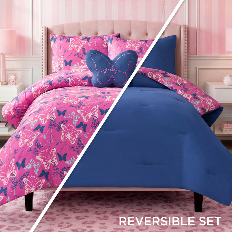 The Kids Wild Butterfly Toss Reversible Comforter Set is displayed: one side features pink with butterfly patterns, while the reverse is a solid blue. A butterfly-shaped pillow rests on the bed. This Juicy Couture bedding brings playful elegance to the room, complemented by pink accents, striped wallpaper, and a patterned rug.
