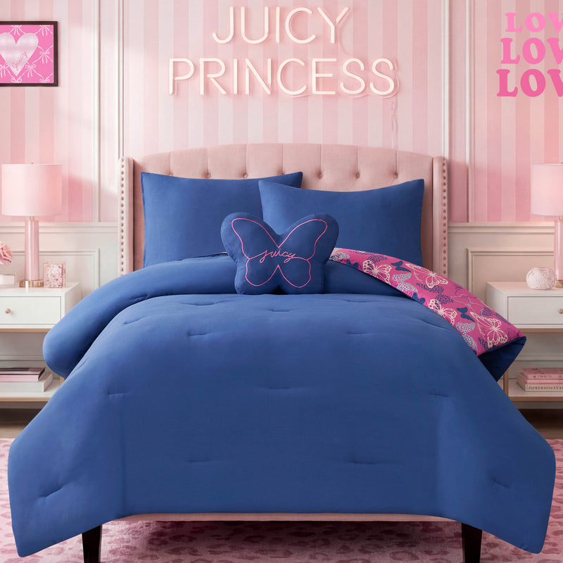 A bed featuring the Kids Wild Butterfly Toss Reversible Comforter Set and a butterfly pillow sits in a pink room with “JUICY PRINCESS” displayed on the wall above, flanked by nightstands and pink lamps, creating a vibrant space perfect for children’s bedding.