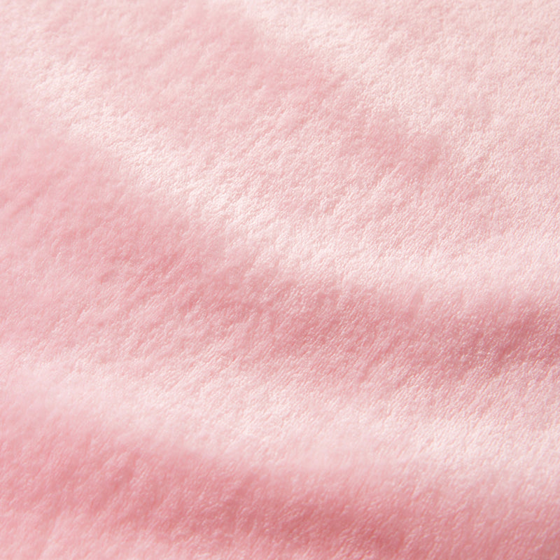 Close-up of the Plush Oversized Throw Blanket, 60″ x 70″, in a soft pink hue with velvety texture, highlighting its gentle folds and smooth, shiny surface—an ultra-soft throw perfect for cozy evenings.