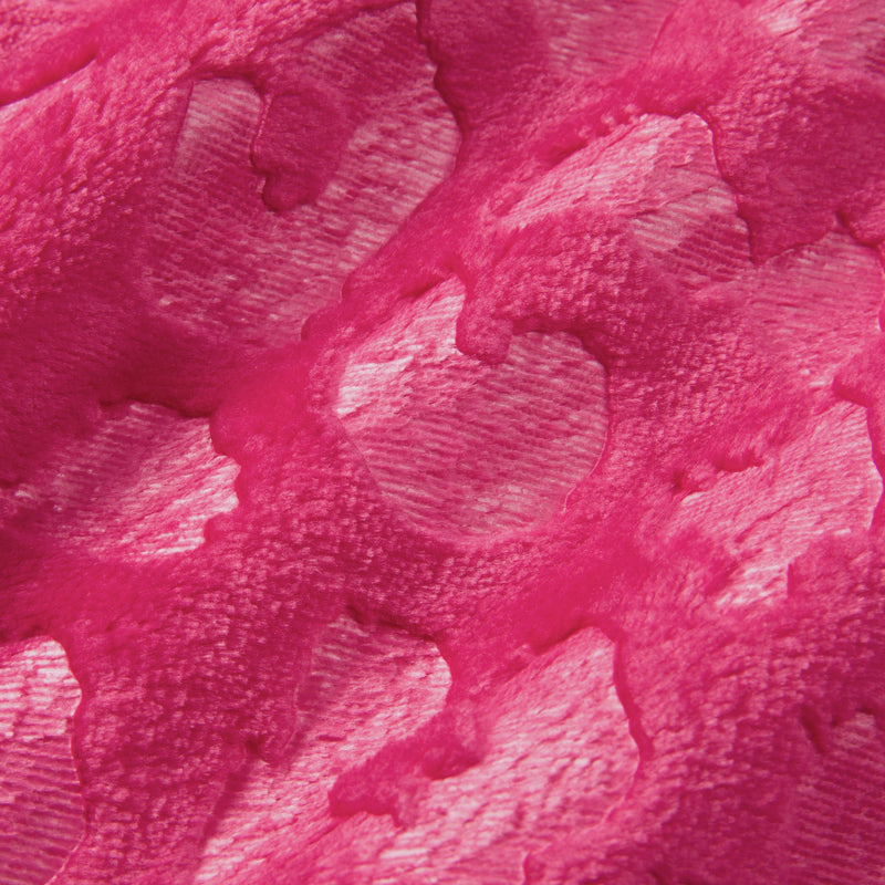 Close-up of a pink textured surface with irregular, heart-shaped and rounded patterns that resemble the embossed design of the Embossed Plush Oversized Throw Blanket. Light reflects off the raised areas, creating a shiny appearance reminiscent of a luxurious, velvety throw.
